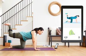 A woman exercises while wearing a sensor that tracks her motion