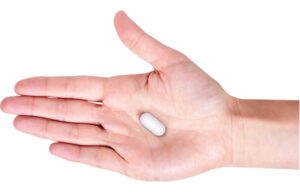 Vibrant Gastro's vibrating pill for constipation treatment in the palm of a hand